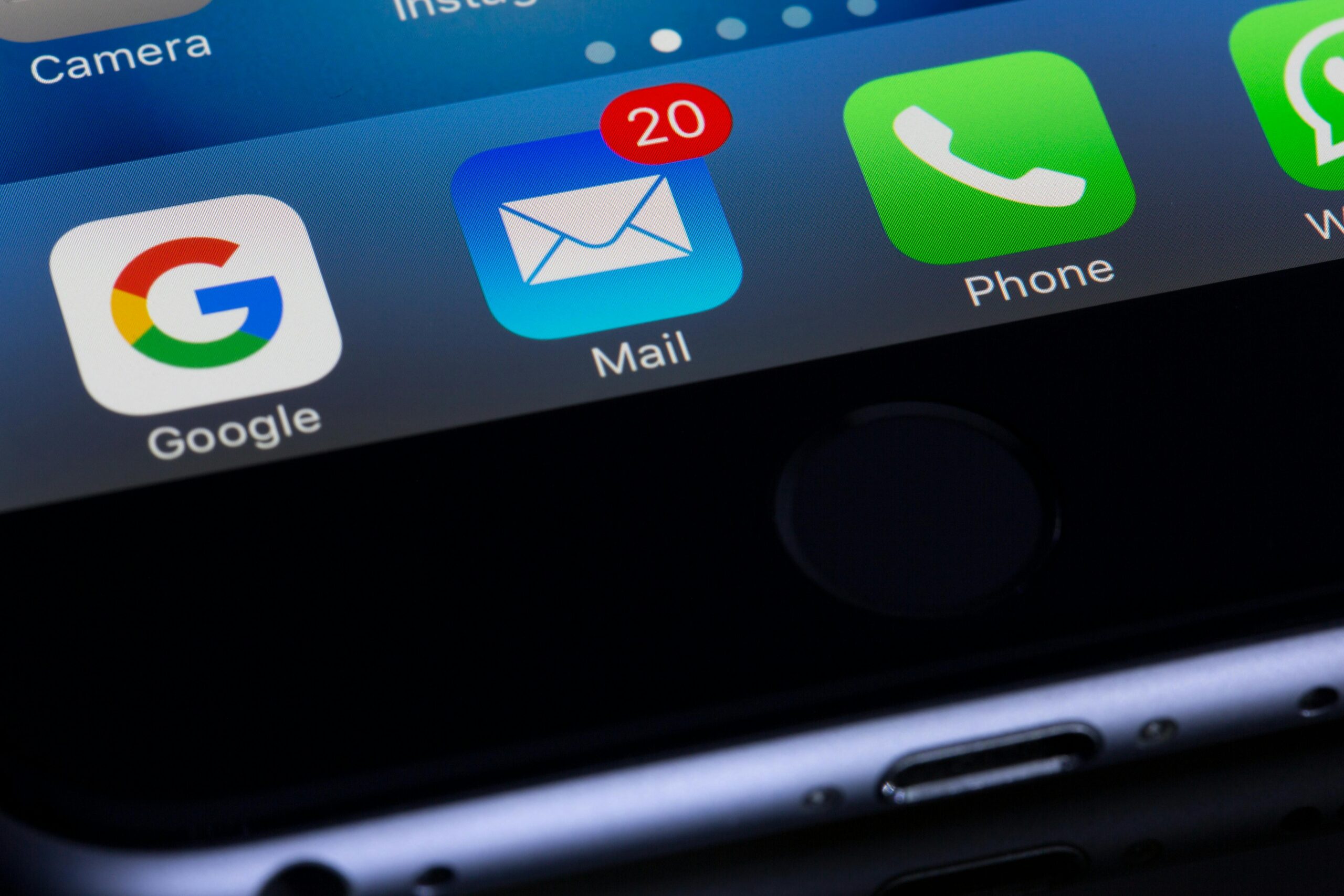 Email Deliverability A close-up photo of a smartphone displaying popular apps like Google and Mail.