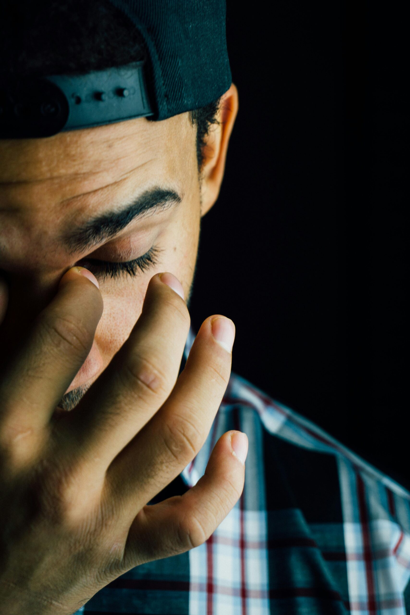 Microsoft extend deadline for Basic Authentication A close-up portrait capturing the emotional expression of a man in a dark studio setting.