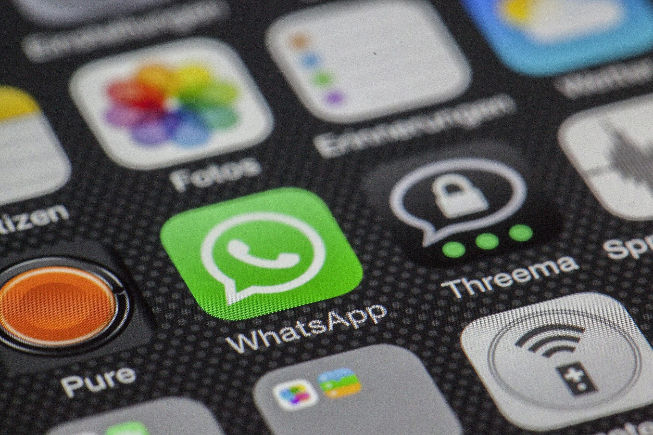 How to add WhatsApp Click to Chat Detailed macro of smartphone screen showcasing popular app icons like WhatsApp.