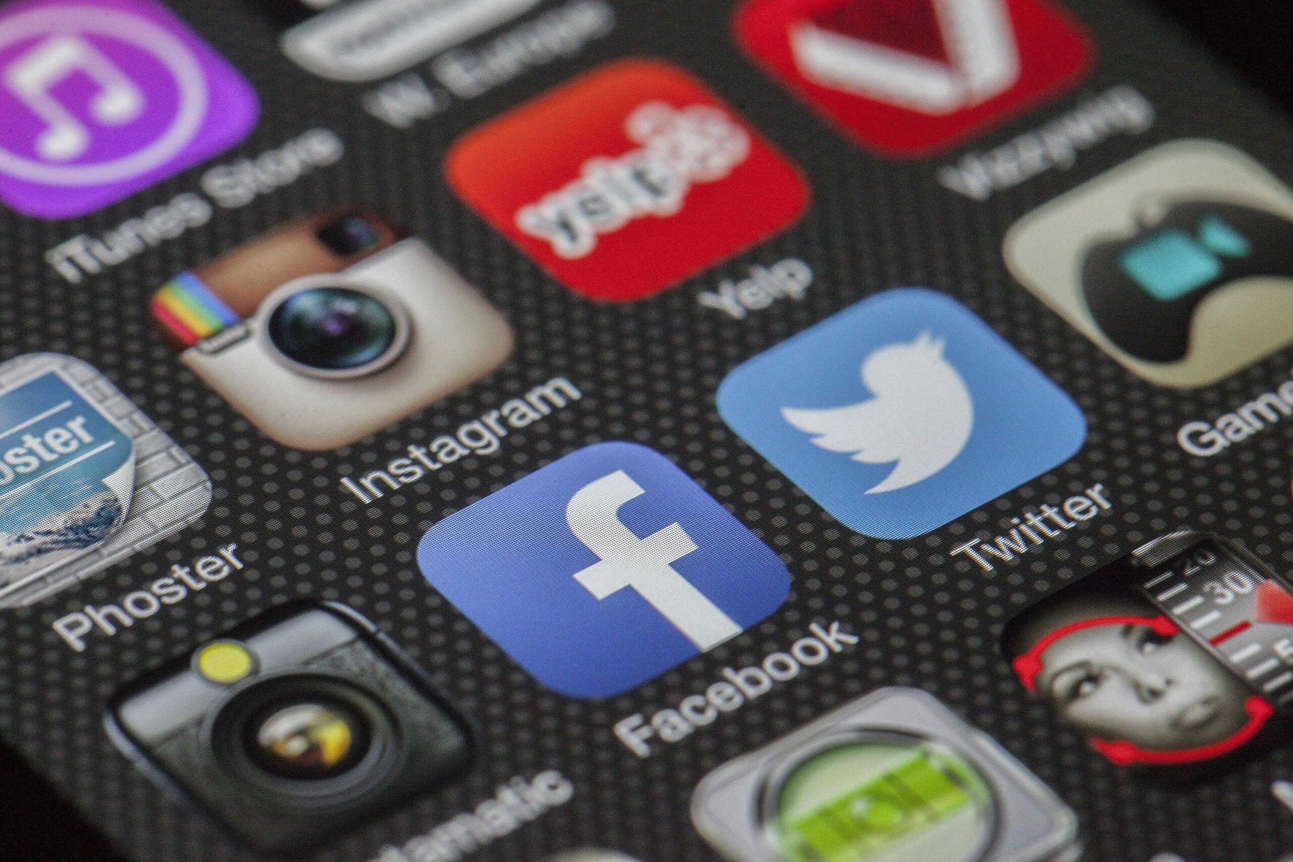 Facebook Pros and Cons Close-up image of various social media app icons on a smartphone screen.